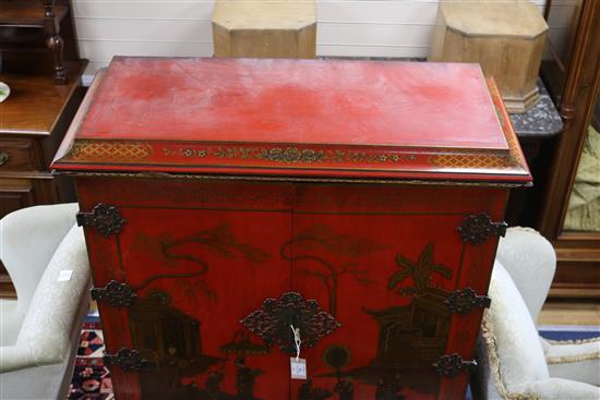 A red lacquer cocktail cabinet on stand, W.105cm